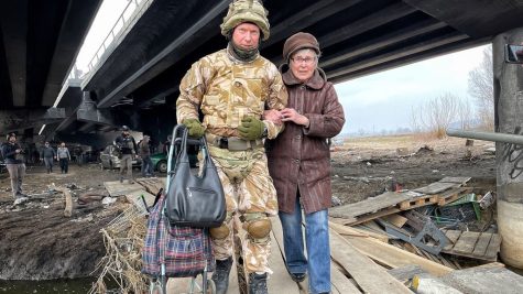 Soldier helping a civilian from Ukraine 