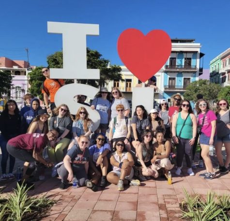 Students and chaperones posing in front of an I heart San Juan sign in Puerto Rico.