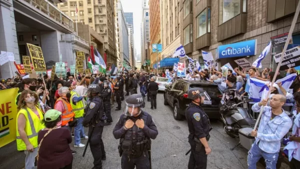 Riot policemen stand between the supporters of Palestine and Israel during the opposing protests. On October 8th, hundreds of people gathered in opposing protests outside the Israel Consulate in San Francisco to express their support for Israel and Palestine amidst a deepening crisis. In response to the escalating tensions, the San Francisco Police Department (SFPD) deployed a group of riot police, some equipped with tear gas guns, to maintain order.