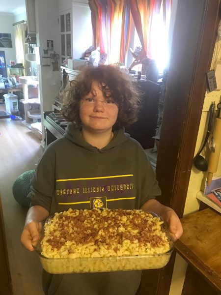Photo of Max Miles making their first baked macaroni and cheese, 2019