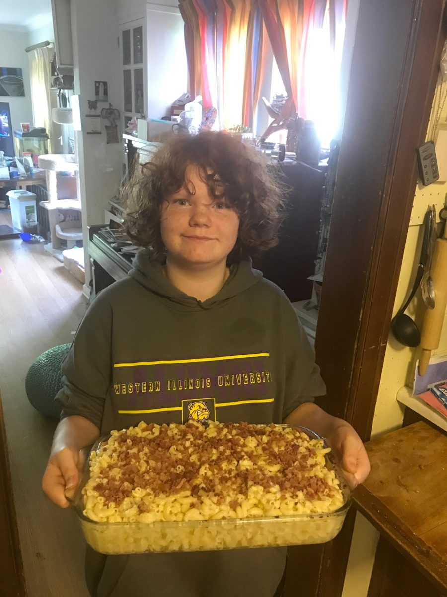 Photo of Max Miles making their first baked macaroni and cheese, 2019
